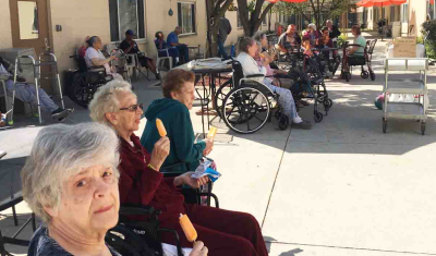 Residents Sitting on the Patio at CedarWoods Enjoying Popsicles